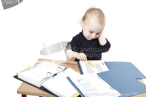 Image of young child at writing desk