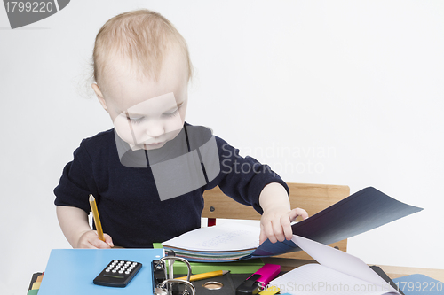 Image of young child at writing desk