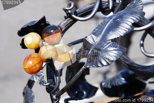 Image of artistic forging with stone grape berries