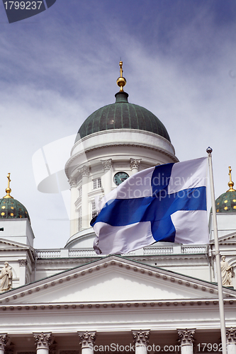 Image of fluttering national flag of Finland against Helsinki Cathedral