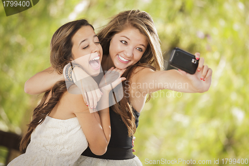 Image of Attractive Mixed Race Girlfriends Taking Self Portrait with Came