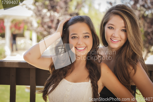 Image of Attractive Mixed Race Girlfriends Smile Outdoors