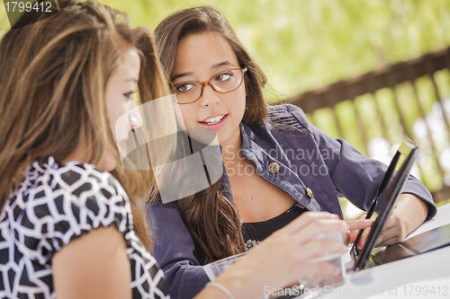 Image of Mixed Race Girls Working Together on Tablet Computer