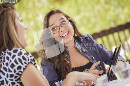Image of Mixed Race Girls Working Together on Tablet Computer