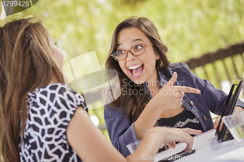Image of Mixed Race Girls Working Together on Tablet Computer