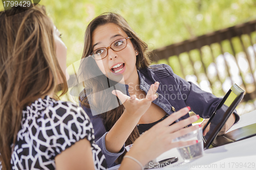 Image of Mixed Race Girls Working Together on Tablet Computer