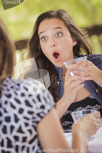 Image of Attractive Shocked Girl Talking with Friend Outdoors