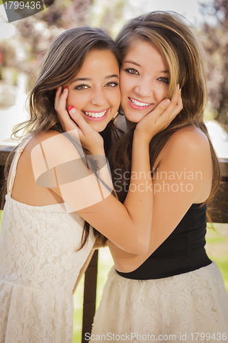 Image of Attractive Mixed Race Girlfriends Smile Outdoors