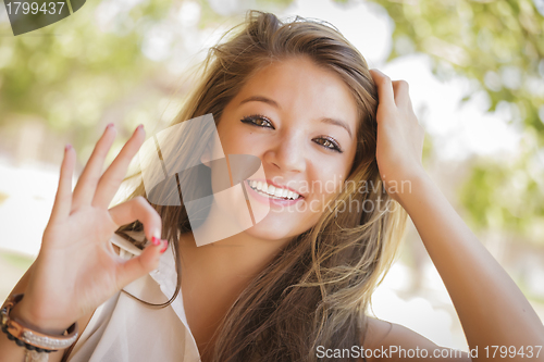Image of Attractive Mixed Race Girl Portrait with Okay Hand Sign Outdoors