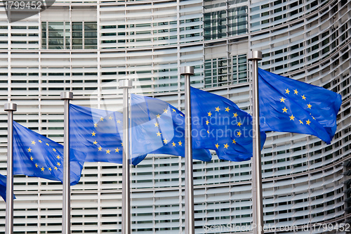 Image of European flags in front of the Berlaymont building, headquarters of the European commission in Brussels.