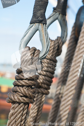 Image of Ancient wooden sailboat pulleys and ropes detail