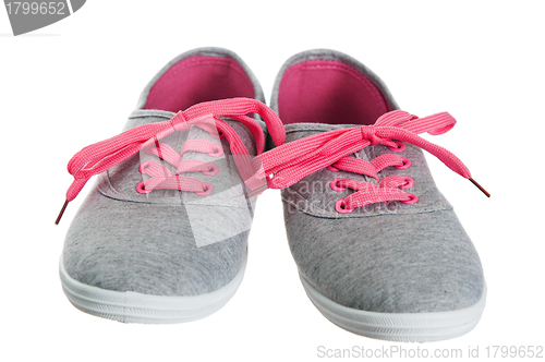 Image of Beautiful female pink sneakers, it is isolated on white