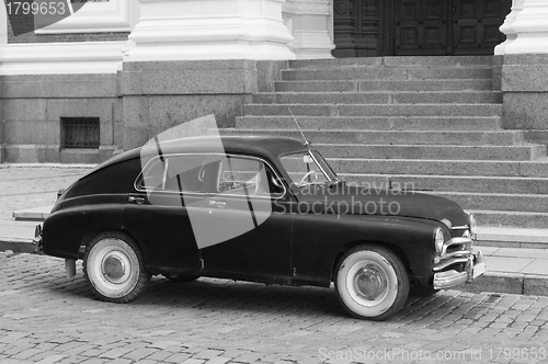 Image of The ancient car parked at a porch of a building