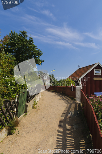 Image of Narrow street and red cottages in Sweden