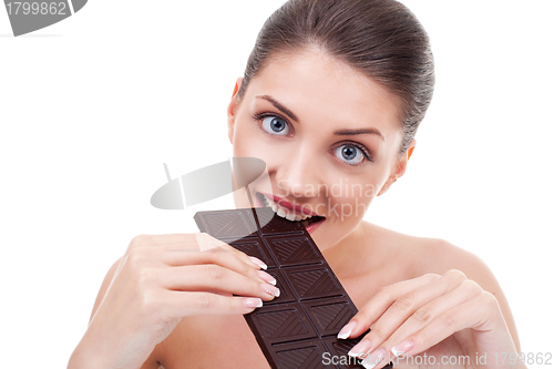 Image of woman, biting chocolate bar