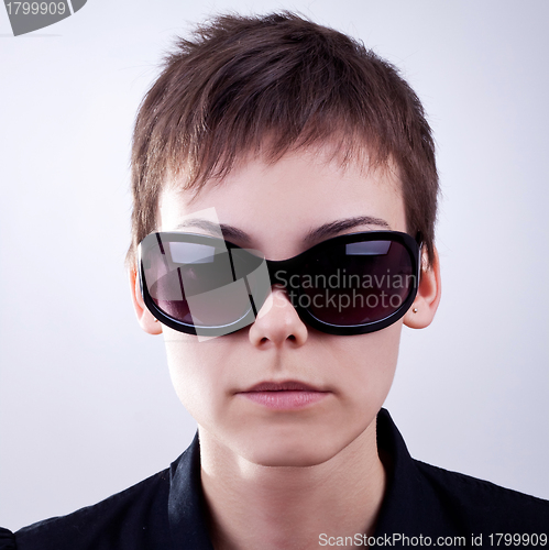 Image of woman face in dark sunglasses 