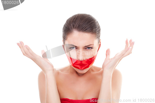 Image of angry woman with  mouth covered 