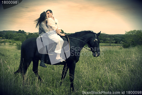 Image of couple and  horse in a field