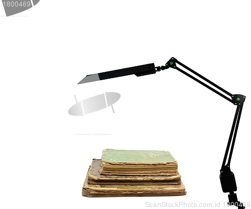 Image of Retro book and modern lamp
