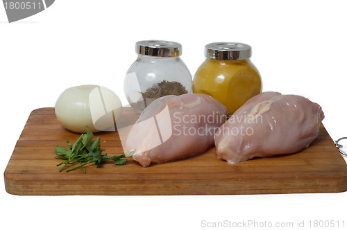 Image of  A pair of skinless chicken breasts on a cutting board