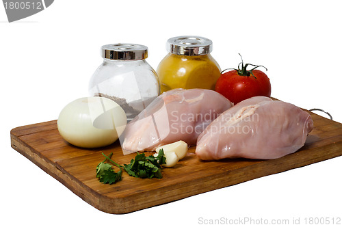 Image of  A pair of skinless chicken breasts on a cutting board