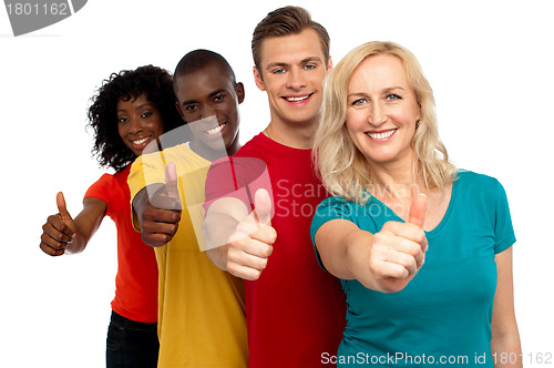 Image of Smiling group of people with thumbs up gesture