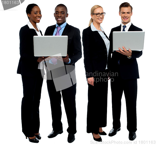 Image of Two business teams posing with laptop