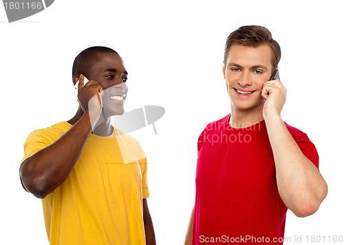 Image of Two handsome men communicating on cellphone