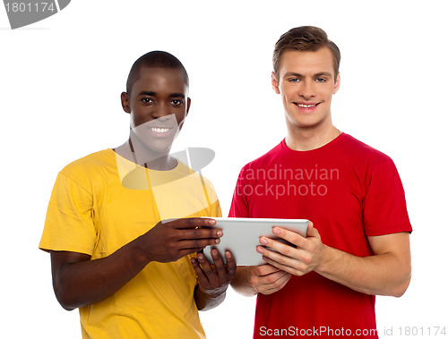 Image of Technology savvy friends using tablet pc