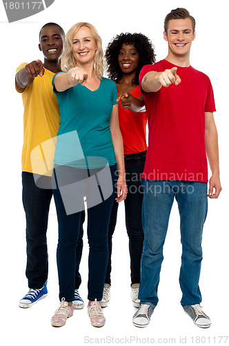 Image of Cheerful group of teenagers pointing at you
