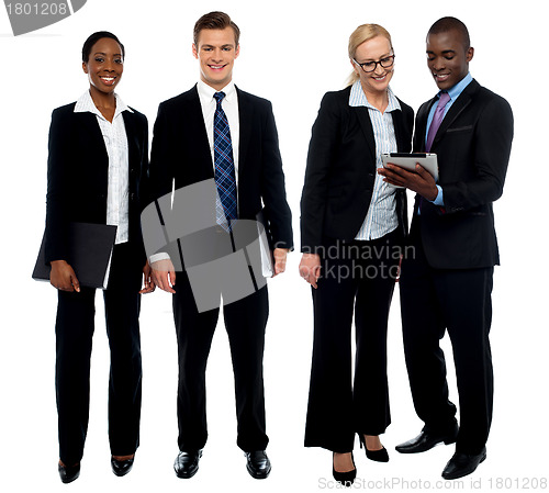 Image of Corporate team of four posing with tablet pc
