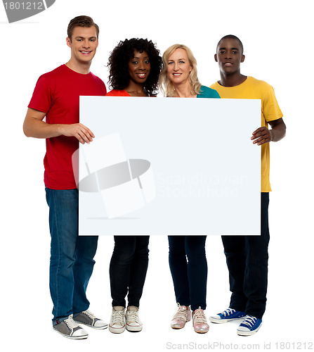 Image of Team of young people holding whiteboard