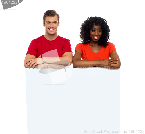 Image of ad, adult, advertise, advertising, african, arms crossed, arms folded, background, billboard, blank, business, casual, caucasian, cheerful, confident, cool, copy space, demonstration, fashion, fashion