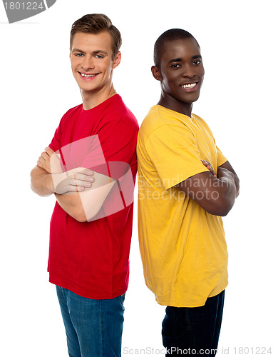 Image of Friends posing back to back with arms crossed