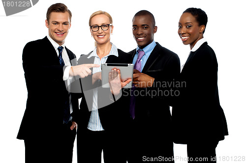 Image of Business people pointing towards wireless tablet