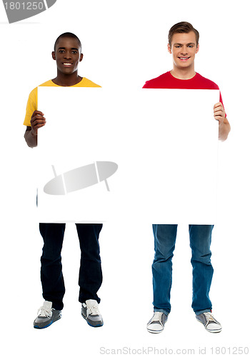 Image of Trendy young guys presenting blank banner ad