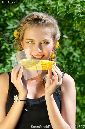 Image of woman eating corn-cob