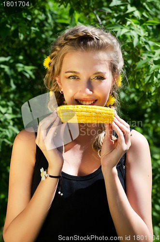 Image of woman eating corn-cob