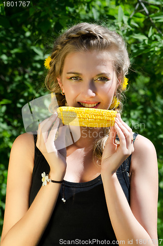 Image of woman eating corn-cob