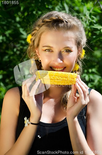 Image of woman eating corn-cob