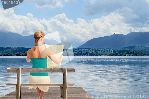 Image of Woman with map on a lake