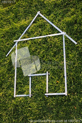 Image of Shape of a house with rule in green grass