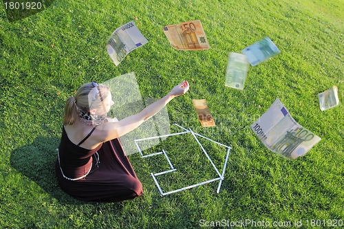 Image of Woman with a house and money