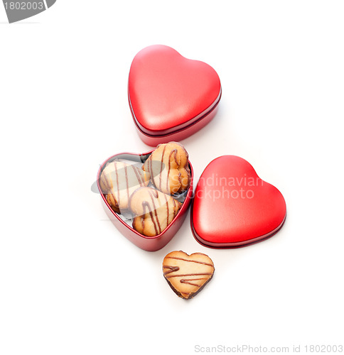 Image of heart shaped cream cookies on red heart metal box