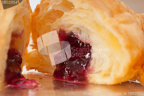 Image of croissant French brioche filled with berries jam