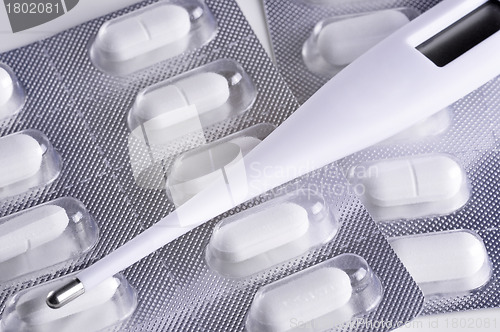 Image of Thermometer and Pills