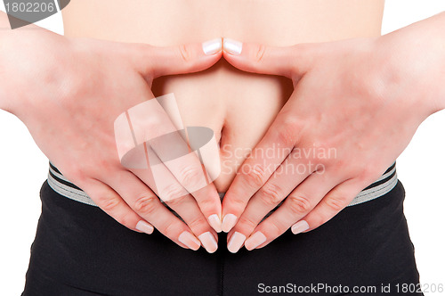 Image of Woman with hands around belly button