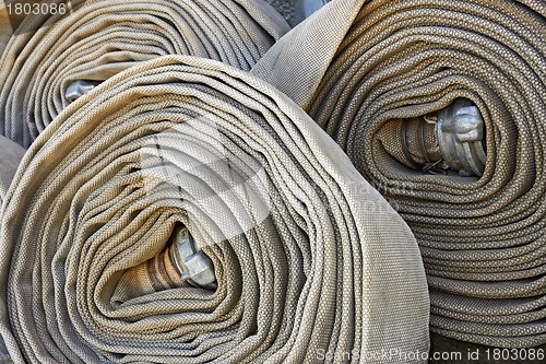 Image of Several old rolled fire hoses