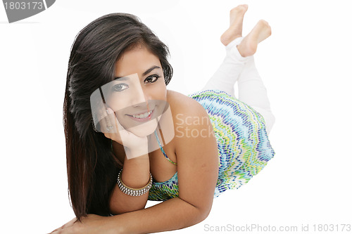 Image of Portrait of a smiling young woman lying on the floor isolated on