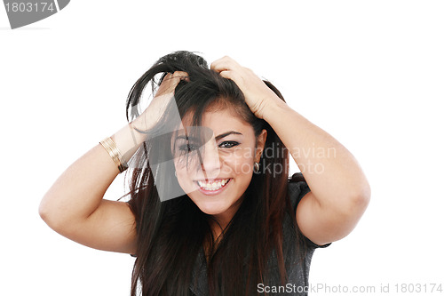 Image of A portrait of a young frustrated woman pulling out hair over whi